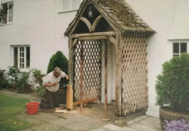 Roger Sach repairing the trellis porch