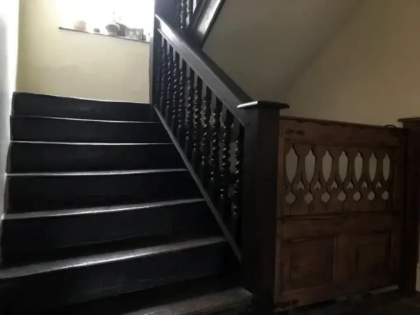 Staircase, possibly from Melksham Court, and contemporary dog gate