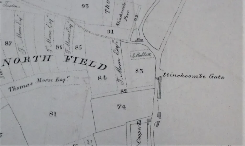 Historical map excerpt showing property plots numbered 74–91 around a curved road labeled Stinchcombe Gate, with 'North Field' and nearby owners' names along the boundaries a few labeled properties.