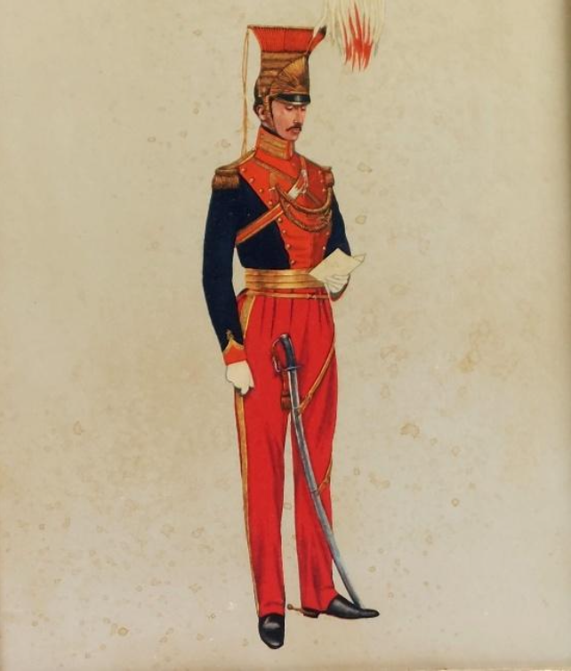 Ceremonial soldier in red trousers and navy jacket, gold braid, and a tall plume helmet, holding a letter with a drawn sabre at his side.