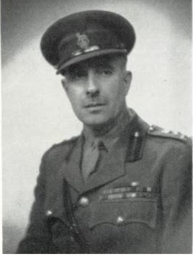 Black-and-white portrait of a male military officer in dress uniform with peaked cap and medals.