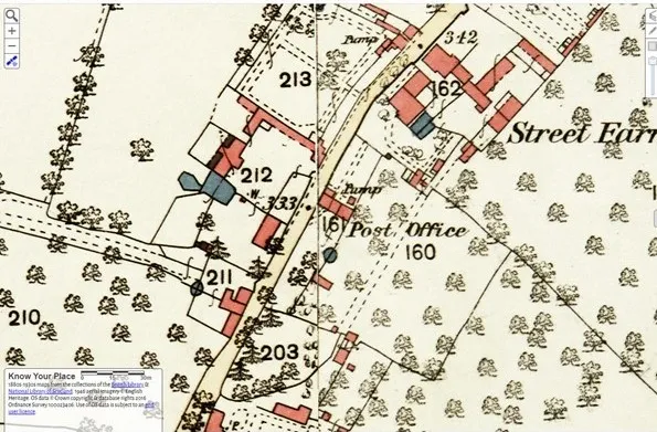 Informational map excerpt showing a rural street with buildings (red) and numbered plots around a Post Office; trees and property boundaries visible along a main road.